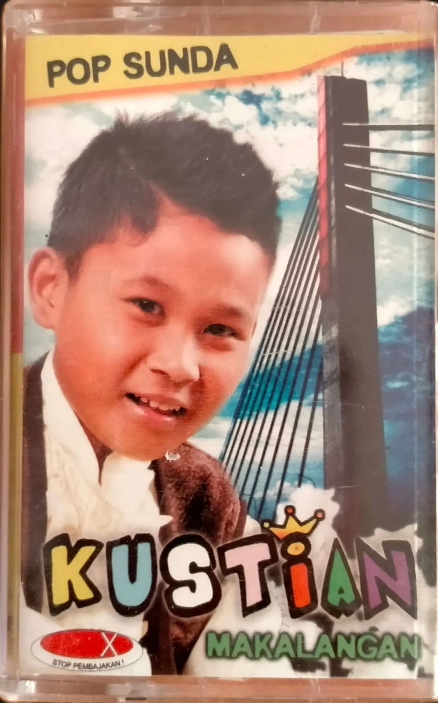 An image of the cassette album cover called «Makalangan» by a smiling child Sundanese artist called Kustian